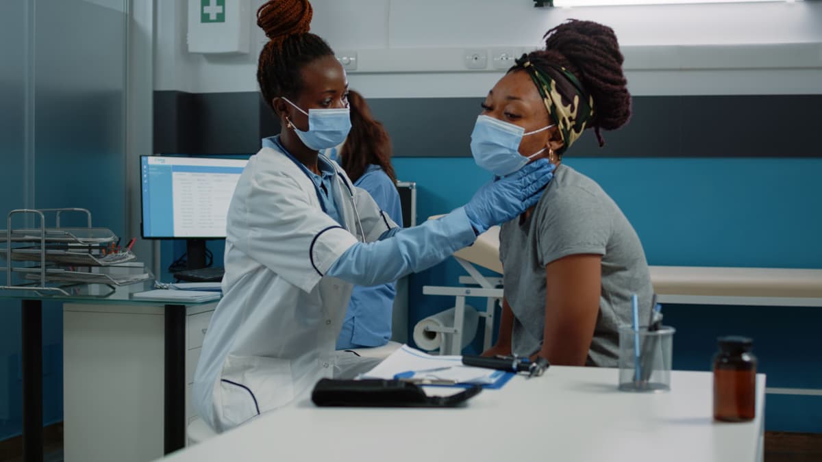 Medical student helping patient